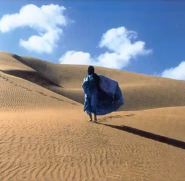 Person walking on sand dunes