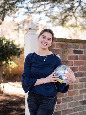 Headshot photo of Education Abroad intern Natalie holding a globe