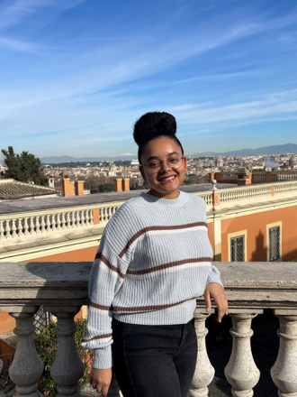 Student intern Rachel McGinnis on a balcony in Rome