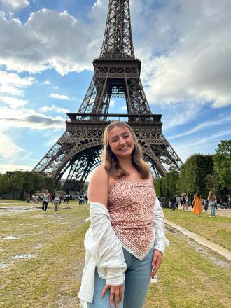 Intern Alice in front of the Eiffel Tower