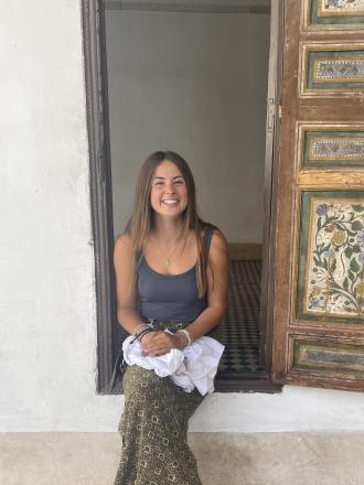Intern Jillian sitting in a doorway