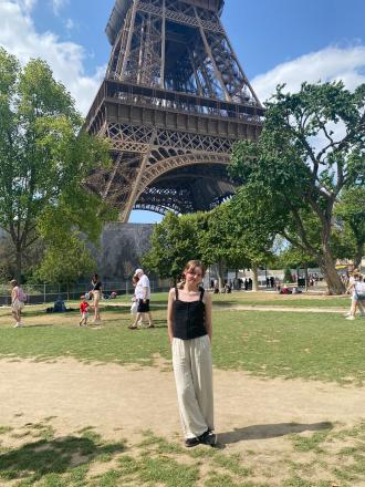 Intern Kieran Warner in front of the Eiffel Tower